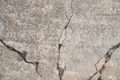 20777777-Texture-background-of-cracked-concrete-road-ground--Stock-Photo.jpg